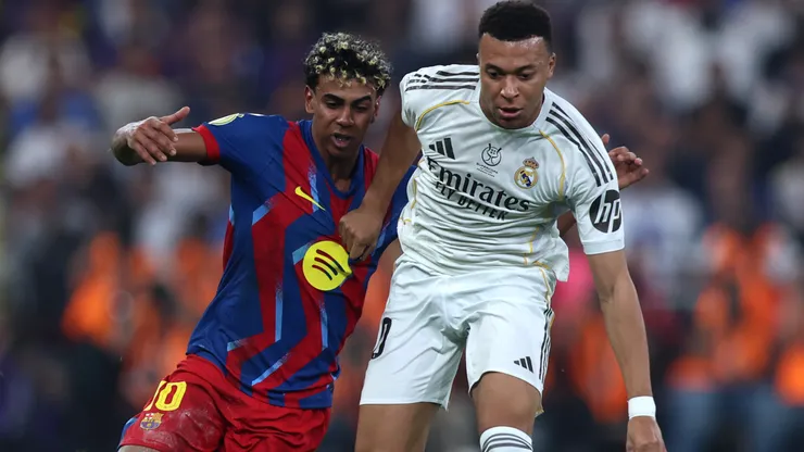Kylian Mbappe of Real Madrid battles for possession with Lamine Yamal of FC Barcelon