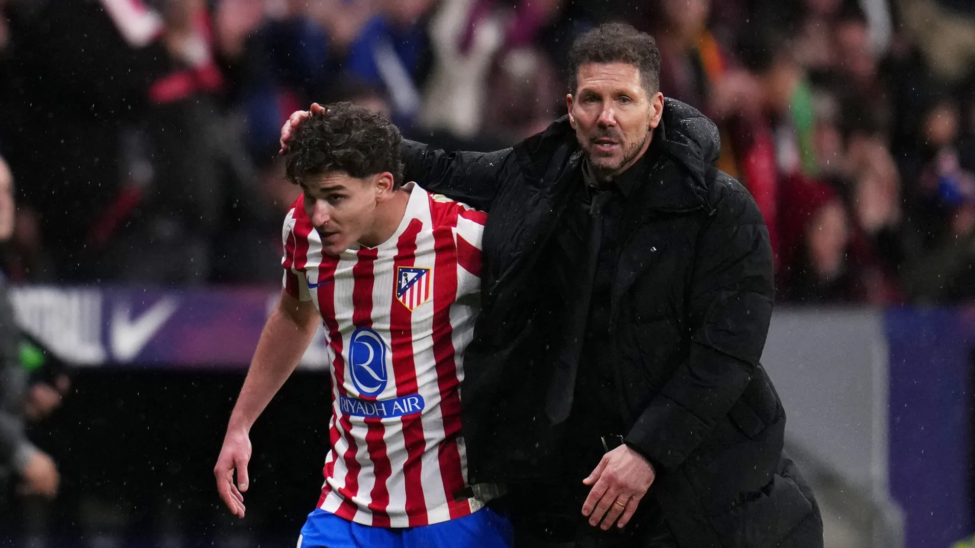 Diego Simeone, Head Coach of Atletico de Madrid, interacts with Julian Alvarez after being subbed off.