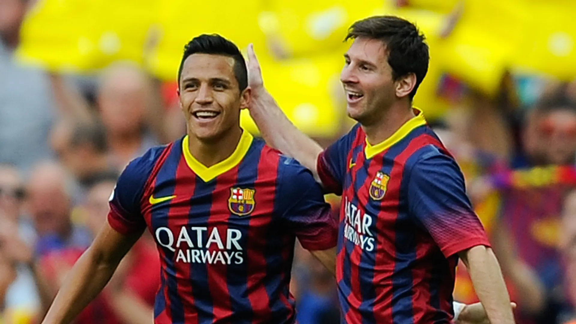 Alexis Sanchez of FC Barcelona celebrates after scoring with Lionel Messi.