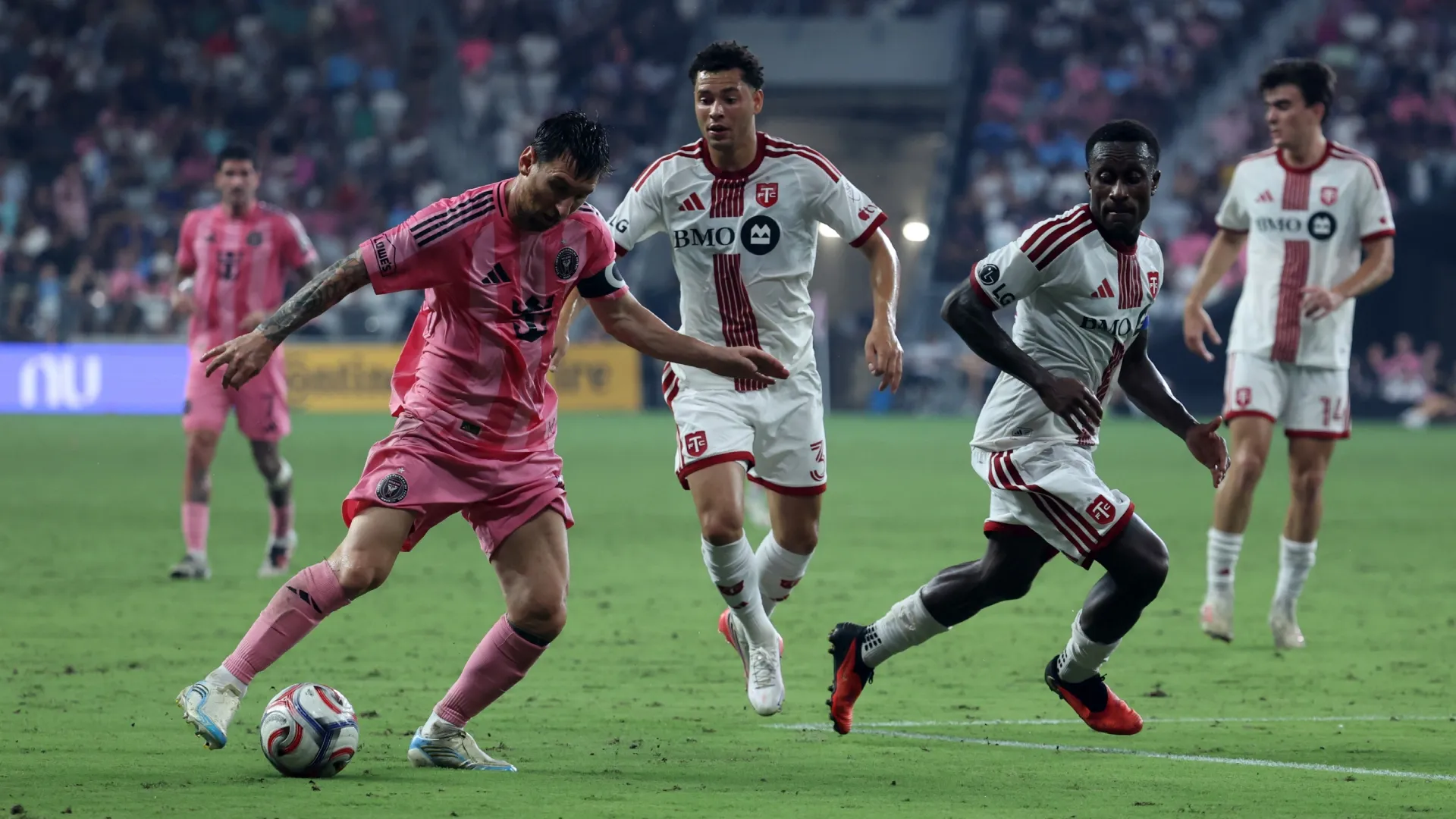 Lionel Messi #10 of Inter Miami CF controls the ball against Richie Laryea #22 of Toronto FC.