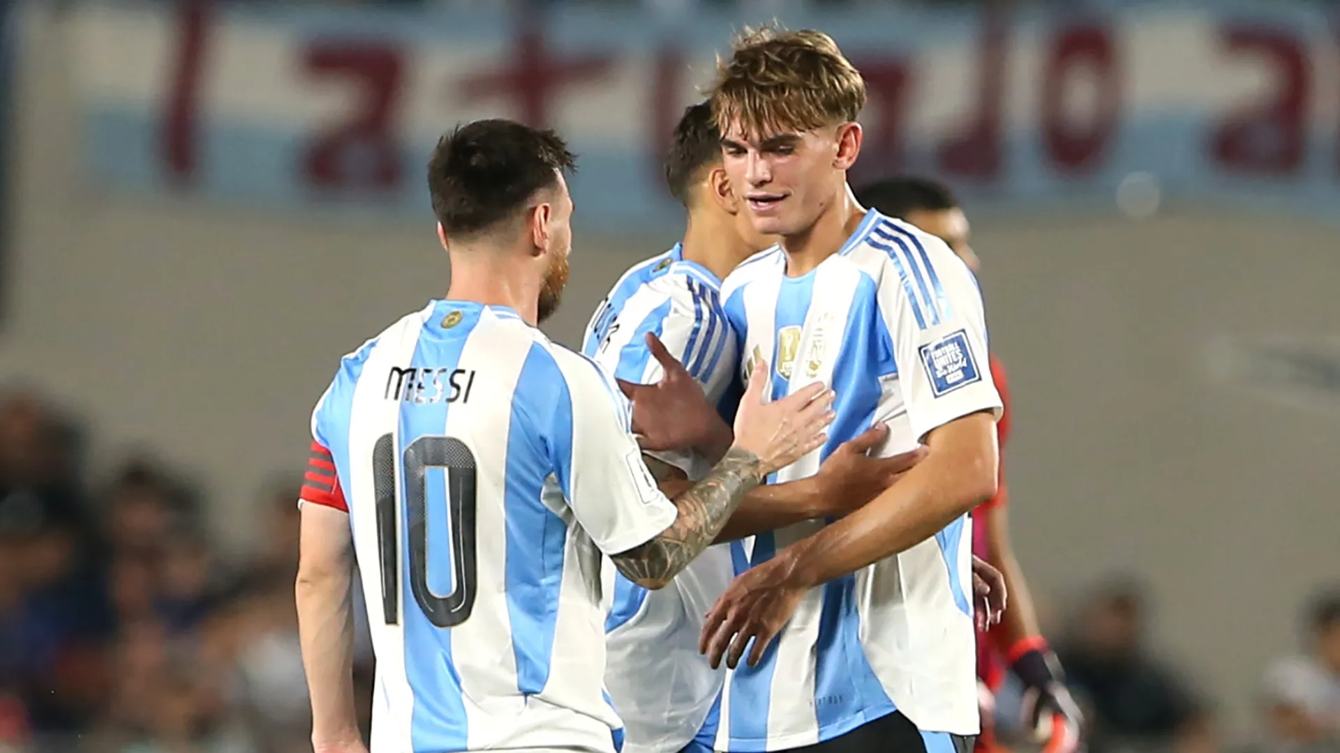 Lionel Messi of Argentina greeting teammate Nico Paz.
