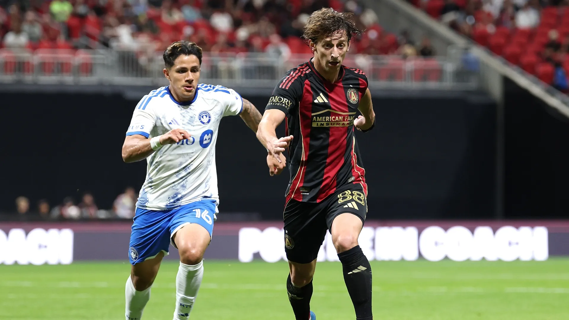 Matías Galarza #88 of Atlanta United runs with the ball against Wiki Carmona #16 of CF Montréal.