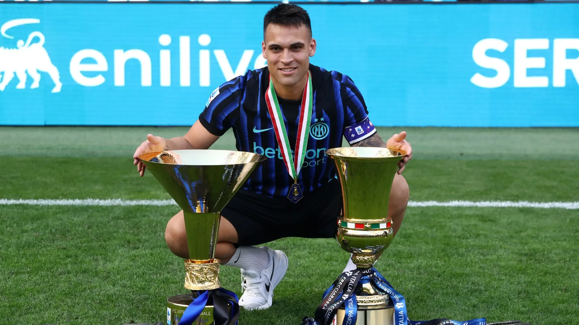 Lautaro Martinez of Inter Milan poses with the Coppa Campioni d'Italia and Coppa Italia trophies