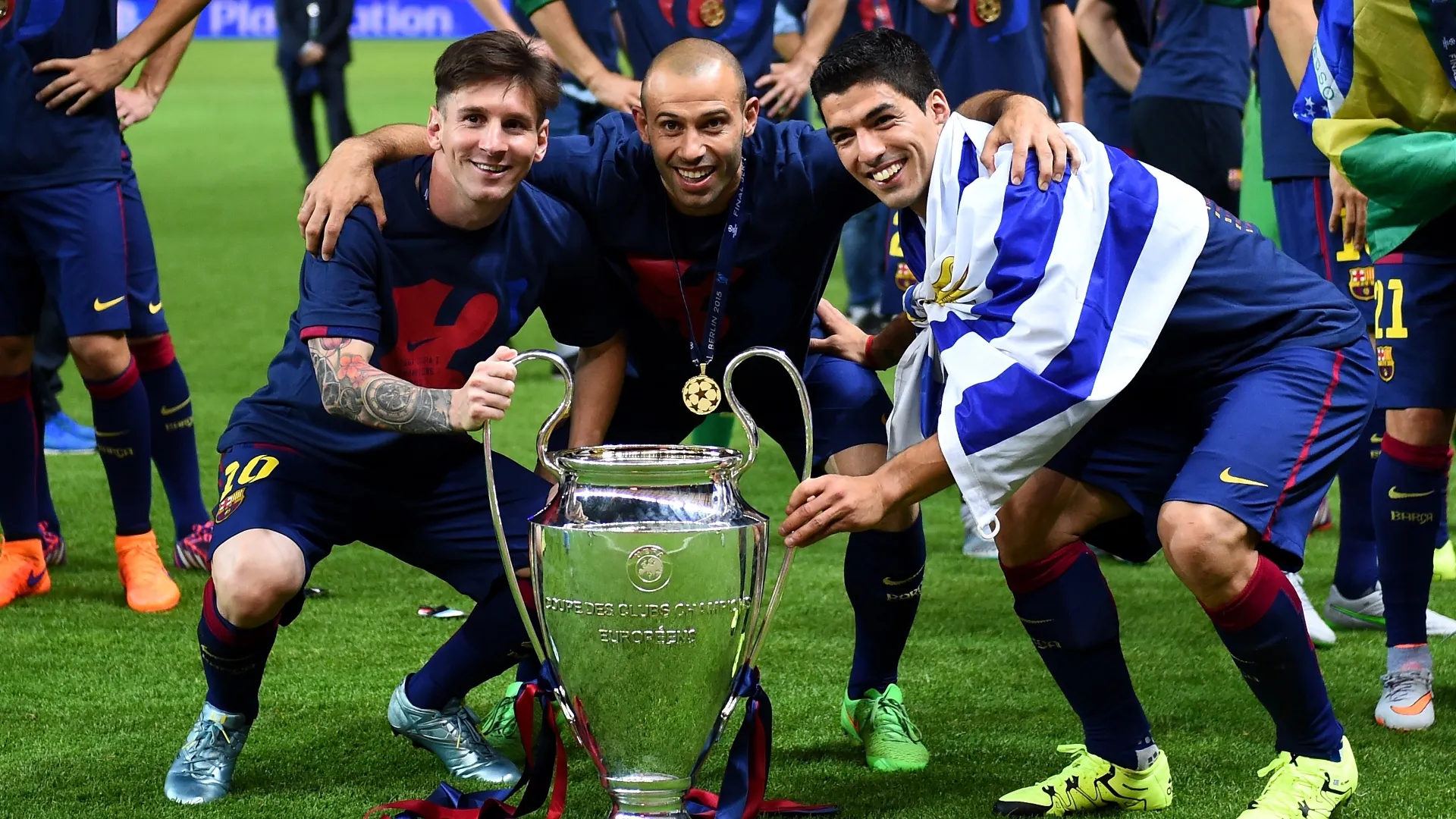 Lionel Messi, Javier Mascherano and Luis Suarez of Barcelona celebrate with the UEFA Champions League trophy.