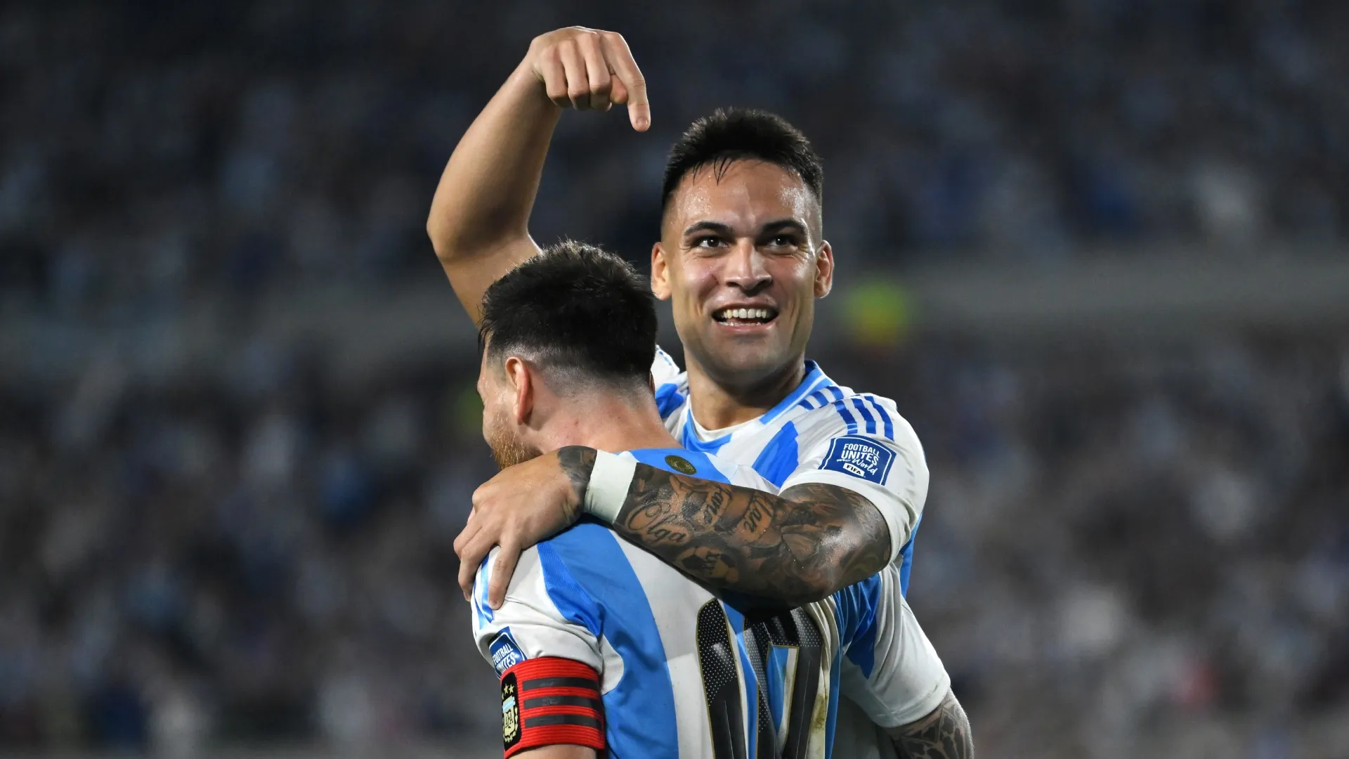 Lautaro Martinez of Argentina celebrates with Lionel Messi after scoring.