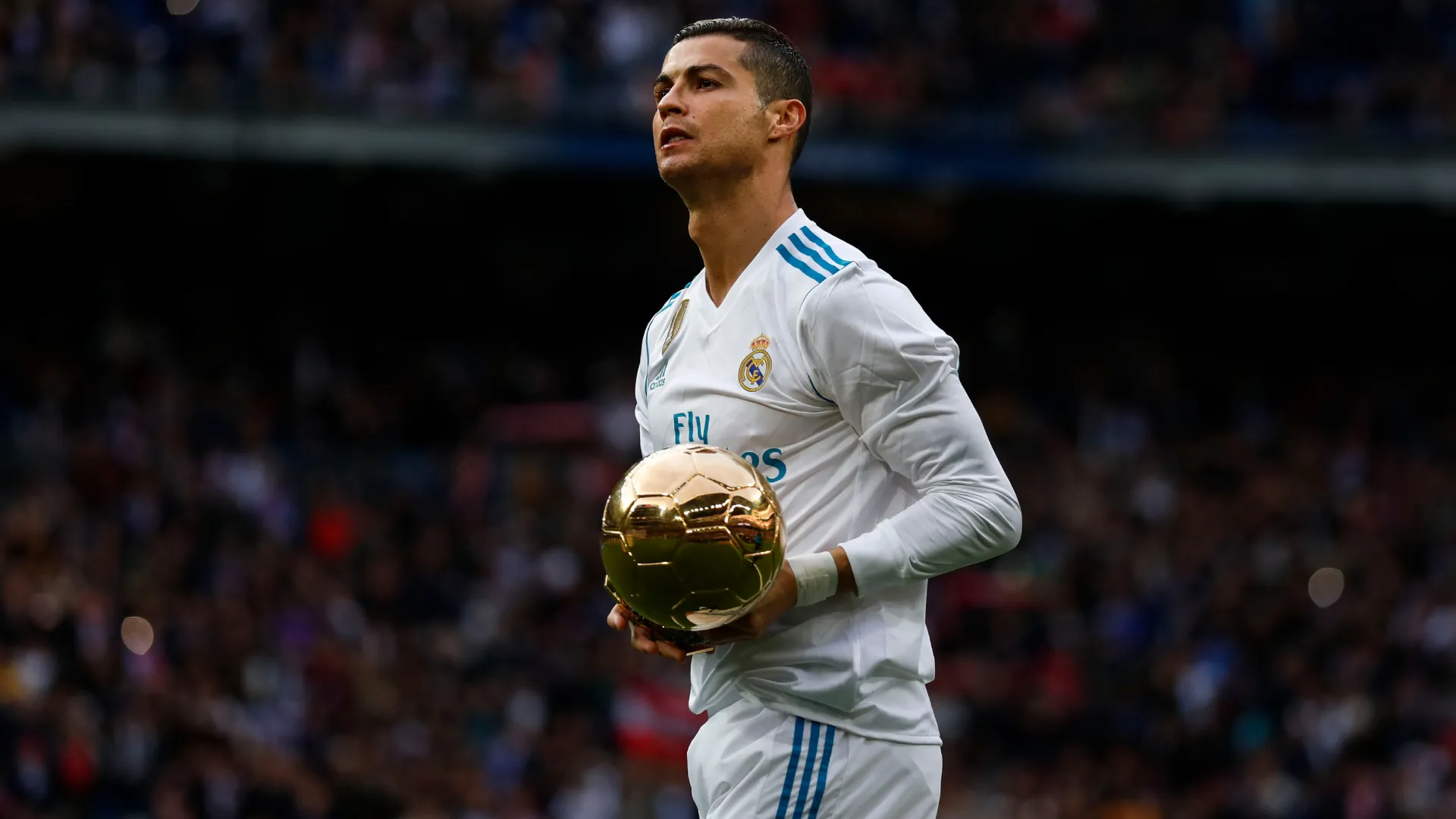Cristiano Ronaldo shows his fifth Ballon d’Or trophy at the Santiago Bernabeu. (Getty Images)