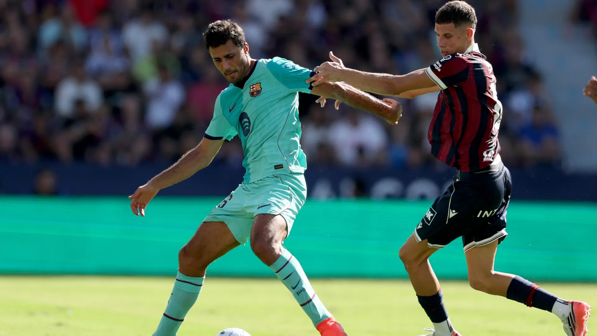 Rodri of Barcelona is challenged by Petar Ratkov of Levante UD.
