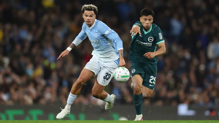 Nico O'Reilly of Manchester City is challenged by Diego Gomez of Brighton & Hove Albion.